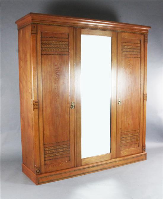 A Victorian Arts & Crafts ash and marquetry bedroom suite, by Heal & Son, triple wardrobe W.6ft1.5in.
